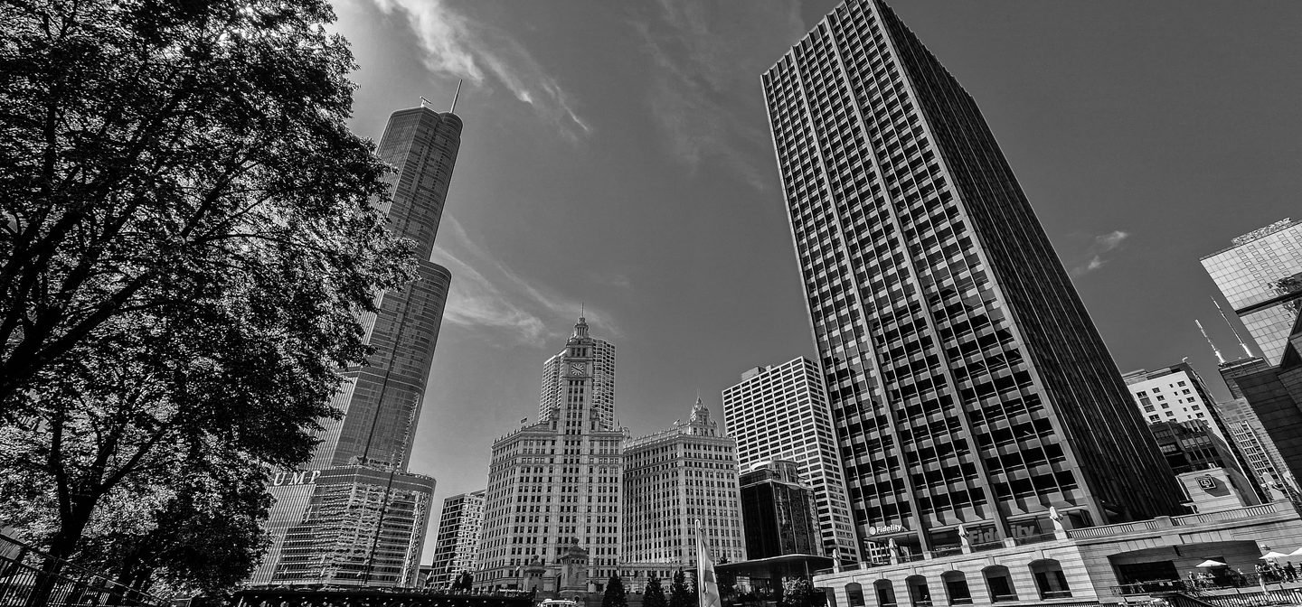 Black and white photograph looking up at the Wrigley Building and towers in Chicago
