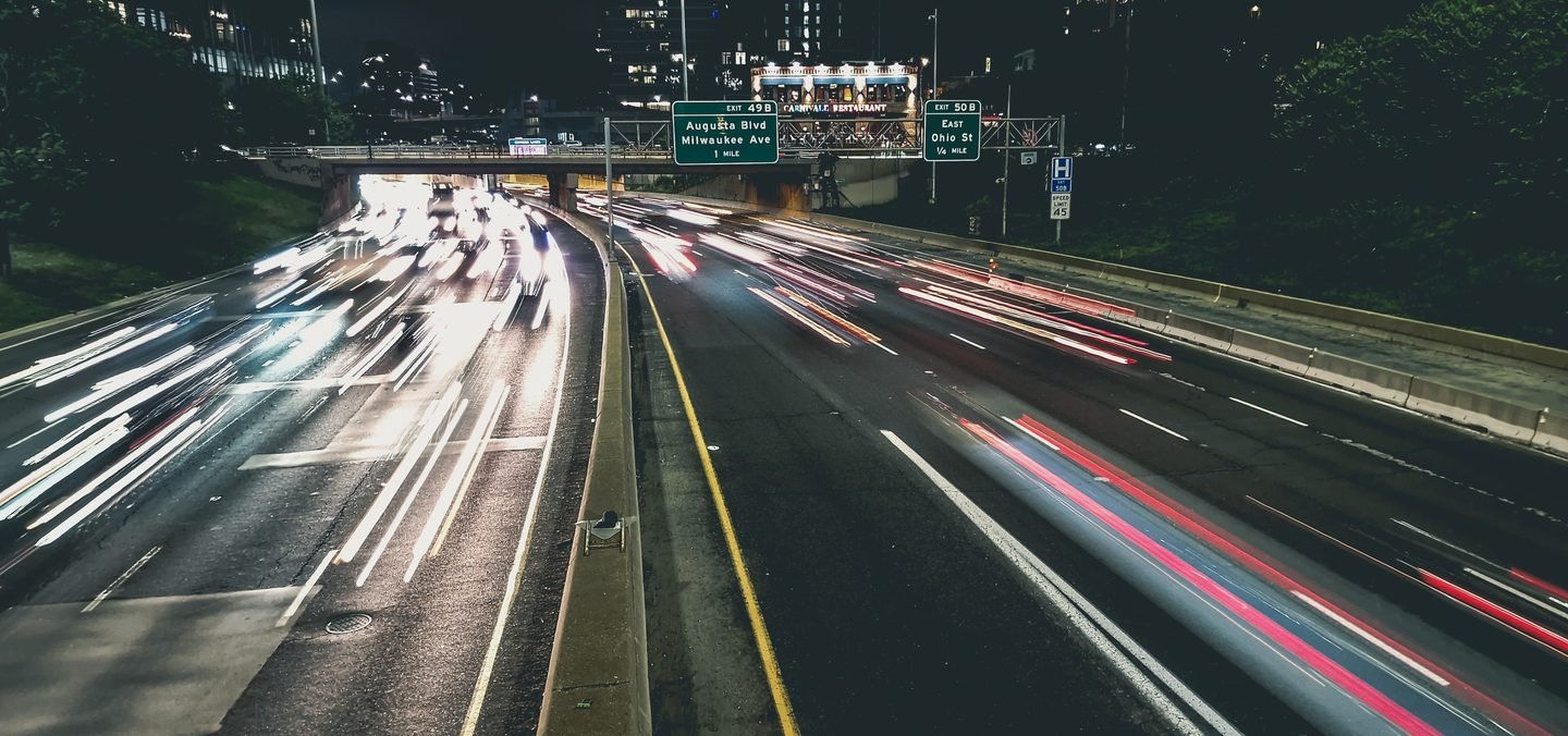 Long exposure of traffic light trails on a Chicago highway at night