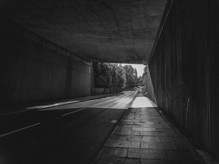 Black and white photograph of an empty road through a tunnel towards daylight, Birmingham lockdown 2020
