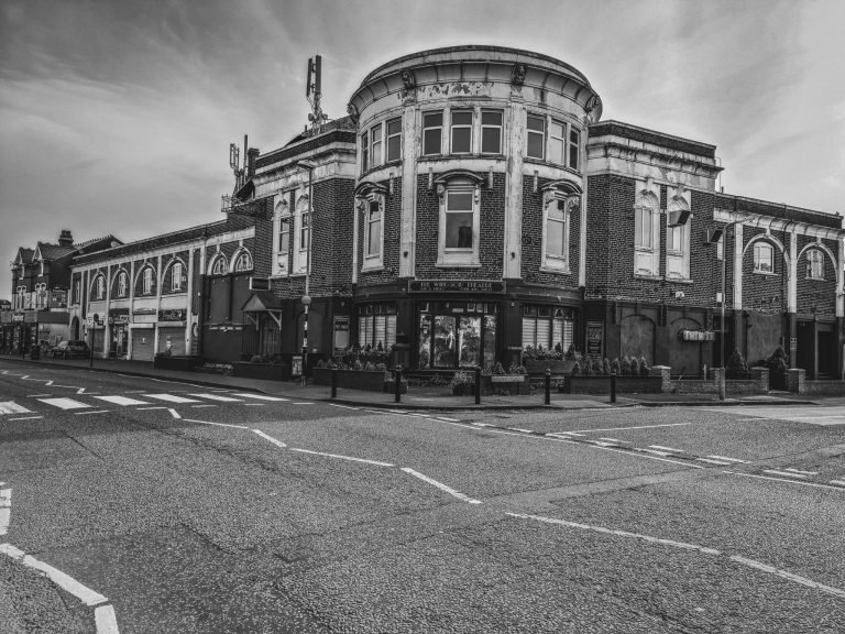Black and white photograph of an ornate corner building above empty crossroads, Birmingham lockdown 2020