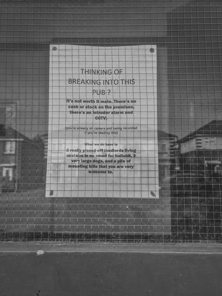 A handwritten warning sign in a closed pub window, Birmingham lockdown 2020