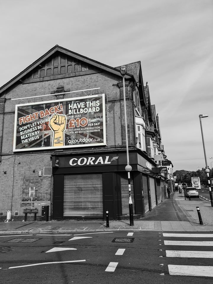 A closed Coral betting shop beneath a Fight Back billboard, Birmingham lockdown 2020