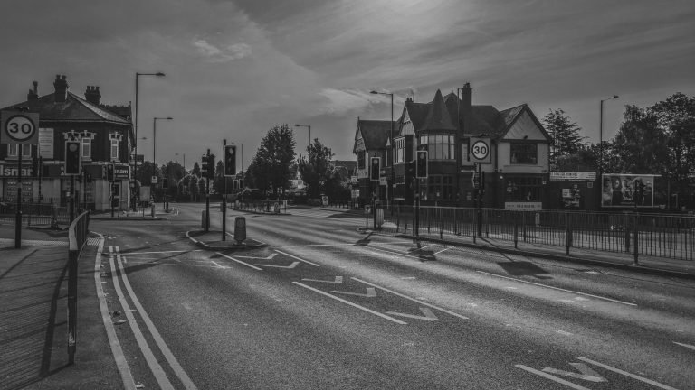 Black and white photograph of an empty road junction lined with houses, Birmingham lockdown 2020